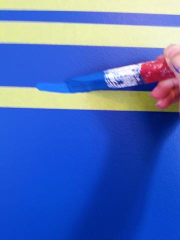 Seal the painter's tape with the same colour paint as the wall.