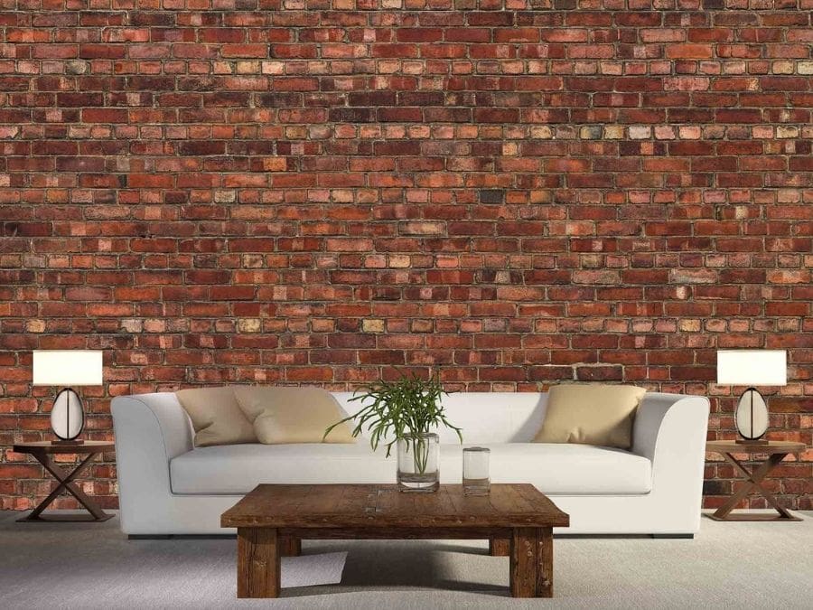 Old Brick Wall Mural, as seen in this cozy living room, is an orange brick wallpaper that's created from a high resolution photo creating a realistic, textured look from About Murals.