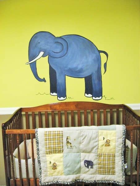An animals mural featuring an elephant, inspired by the bedding, painted by Adrienne of AboutMurals.ca