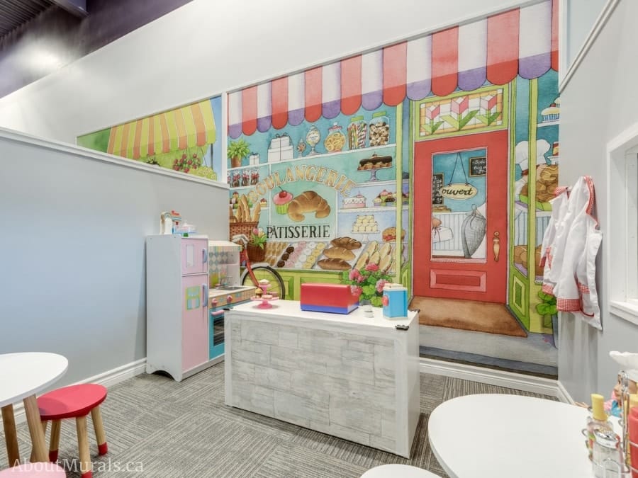Bakery Wall Mural, as seen in this indoor play center, features a bakery full of doughnuts, cookies, cakes and candy. Kids wallpaper sold by AboutMurals.ca.