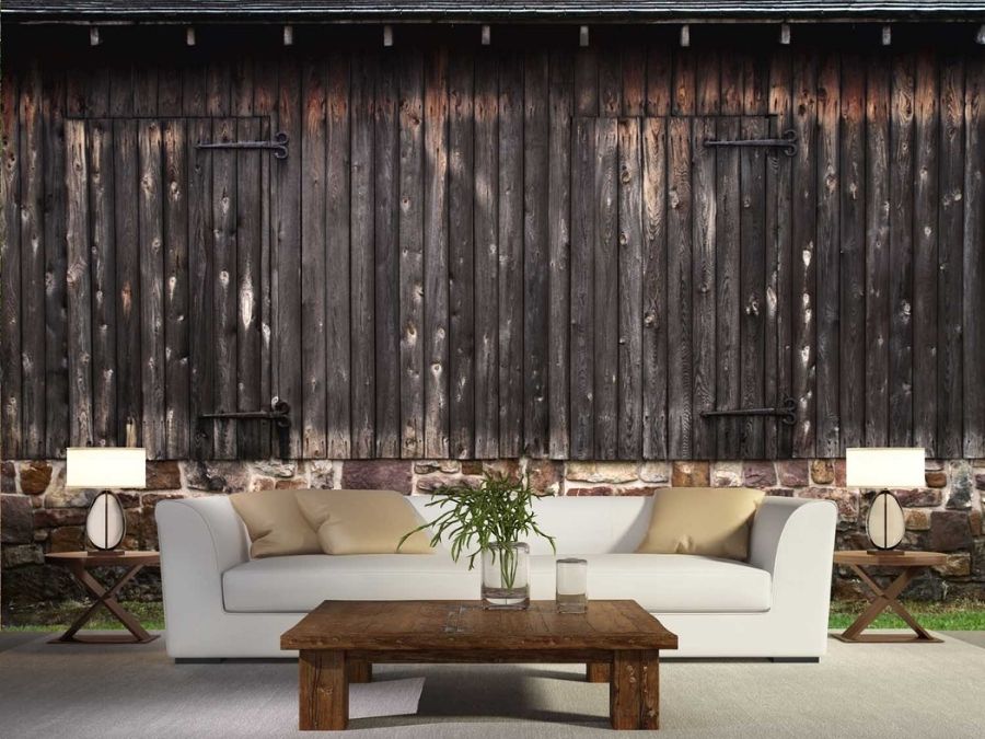 Barn Doors Wall Mural, as seen in this living room, features rustic wooden plank barn doors on a stone foundation from About Murals.