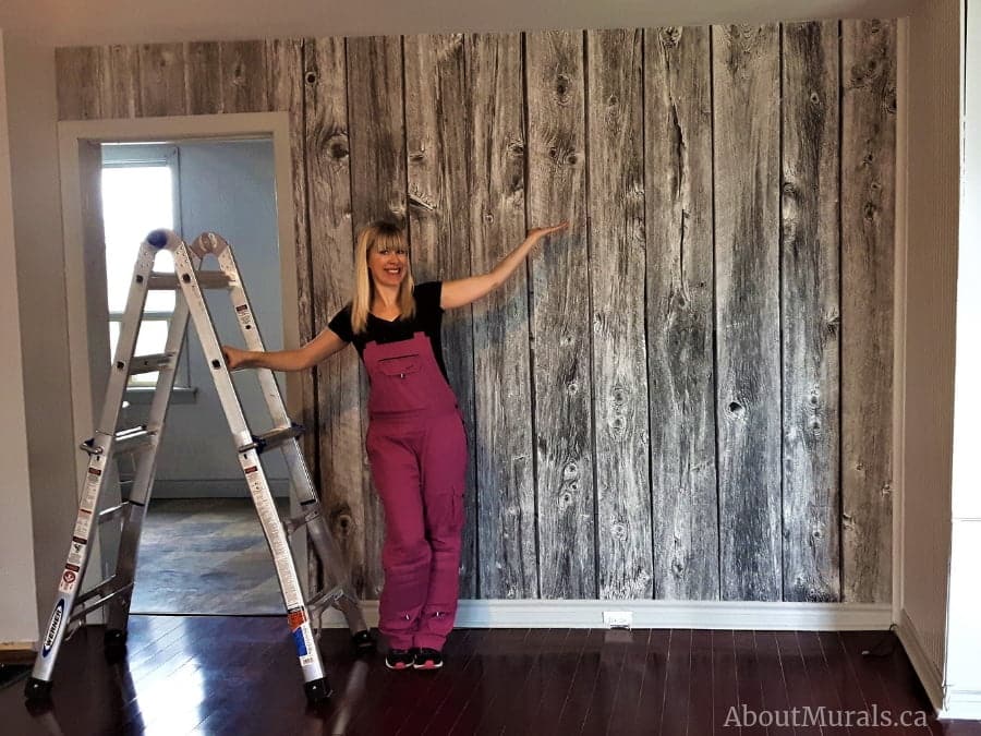 A barn wood wall mural black and white in a living room. Sold by AboutMurals.ca.