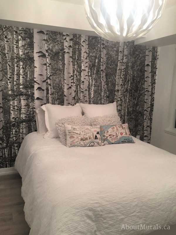 Birch Tree Forest Black and White Wall Mural, as seen in this white bedroom, feels peaceful with its tall trees. Forest wallpaper sold by AboutMurals.ca.