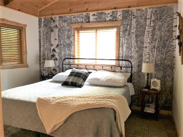 Black and White Birch Tree Wallpaper, as seen on the wall of this cottage, is a photo mural of tall textured trees in nature from About Murals.