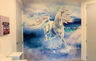 Blue Horse Wallpaper, as seen on the wall of this girls bedroom, is a kids mural of a mystical horse galloping through ocean waves from About Murals.