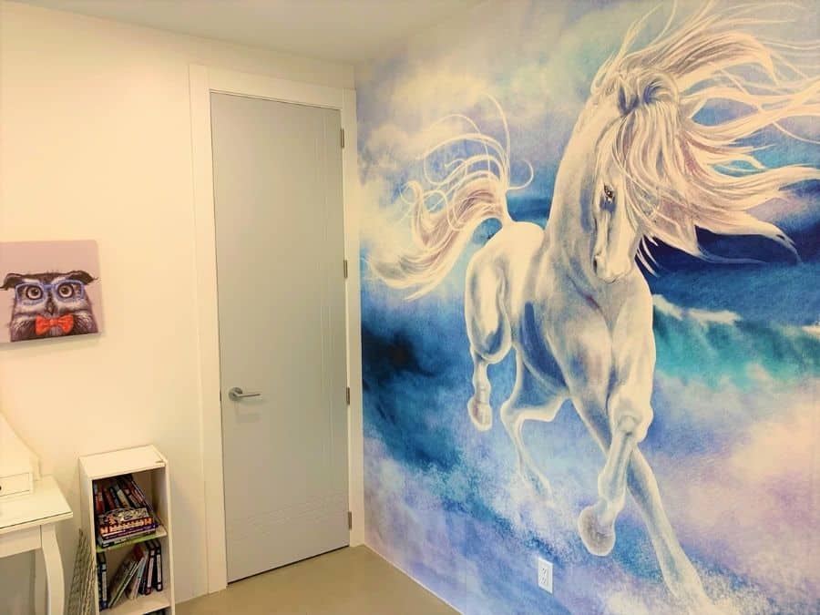 Blue Horse Wallpaper, as seen on the wall of this kids room, is an animal mural of a magical horse galloping through ocean waves from About Murals.