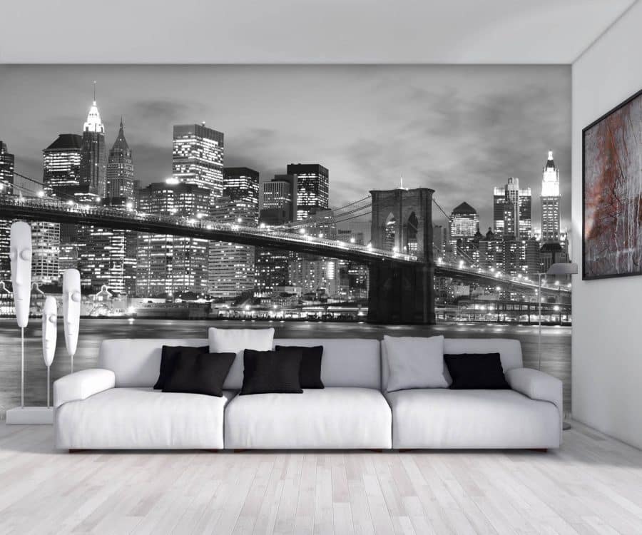 NYC Bridge Wallpaper, as seen on the wall of this light living room, is a photo wallpaper of a bridge in NYC in front of skyscrapers and buildings from About Murals.