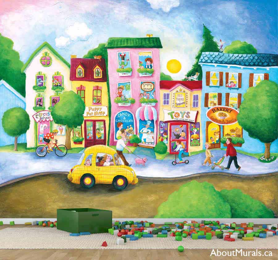 Children’s Town Wallpaper Mural, as seen on the wall of this kids room, is a colorful kids wall mural with people walking pets past a whimsical circus school, pet shop, candy store, toy shop and bakery from About Murals.
