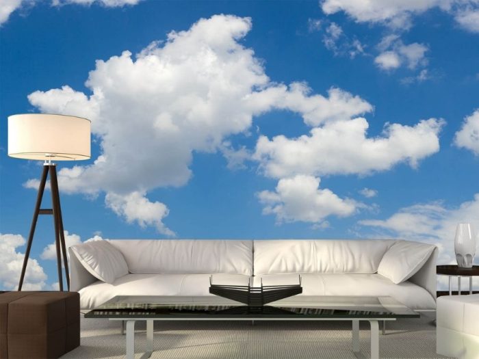 Cloud Wall Mural, as seen in this living room, is a blue sky wallpaper with white clouds from About Murals.