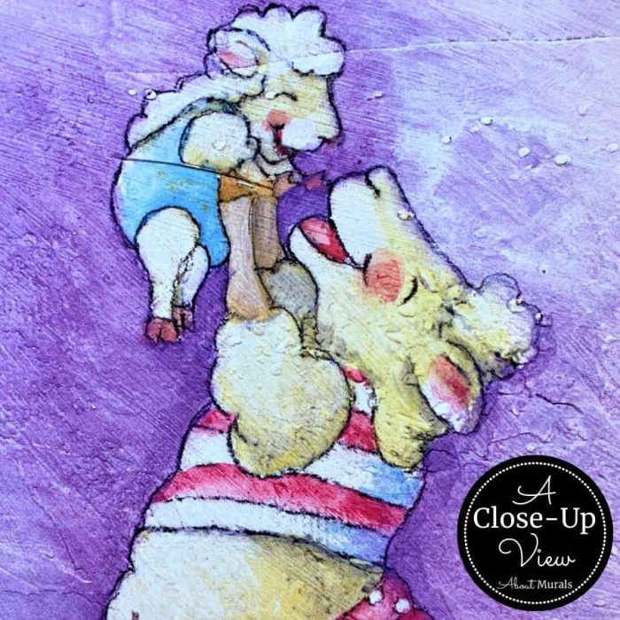 A close-up view of a sheep playing with her baby in a farm mural from About Murals.