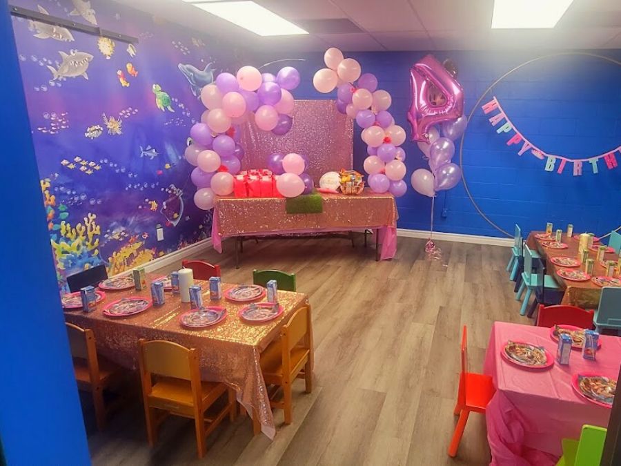Fish Wall Mural, as seen in this birthday party room, is a children’s underwater wallpaper featuring animated dolphins, sharks, fish and sea turtles in the blue ocean from About Murals.