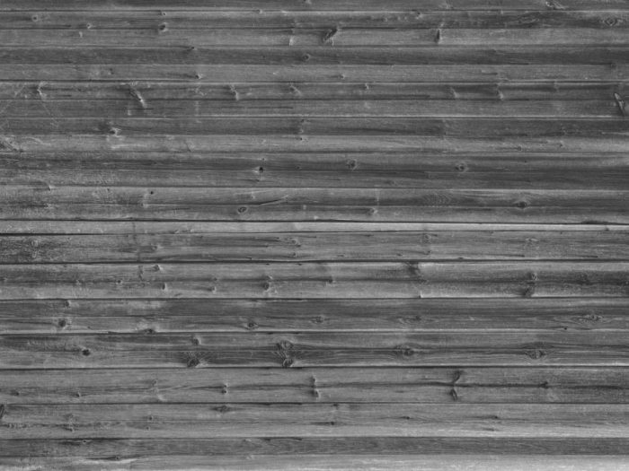 Horizontal Barn Wood Wall Mural Black and White is a realistic wood effect wallpaper in a gray colour from About Murals.