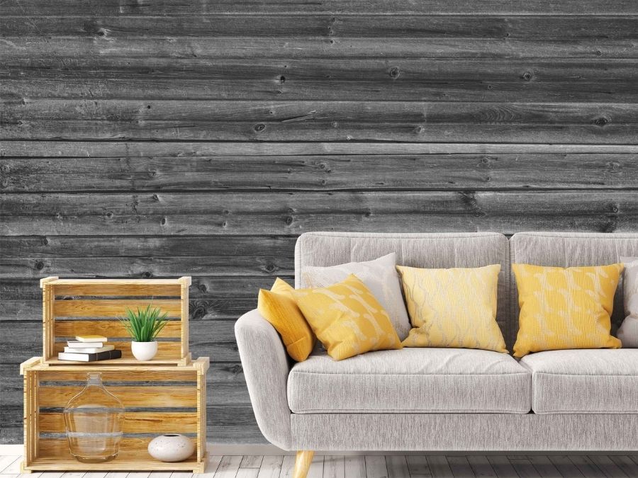 Horizontal Barn Wood Wall Mural Black and White, as seen on the wall of this grey and yellow living room, is a grey wood wallpaper with textured planks from About Murals.
