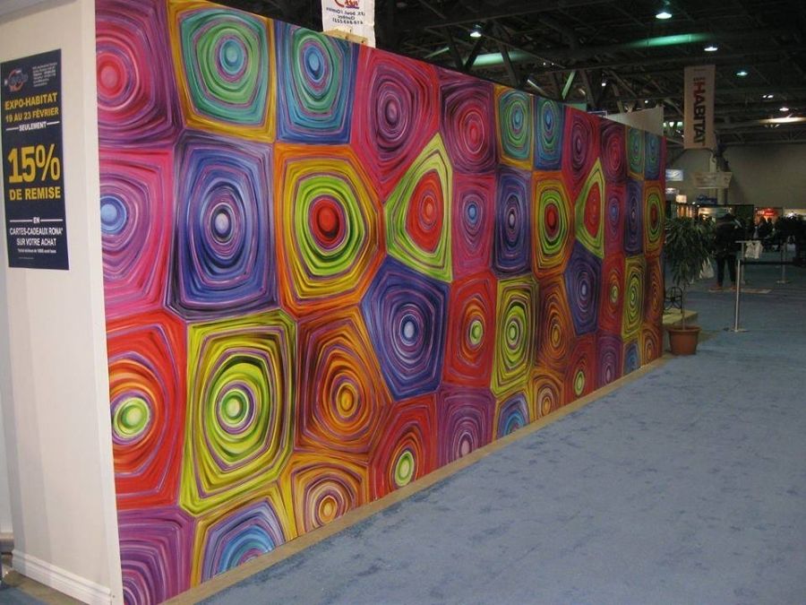 Hypnosis Wall Mural, as seen on this wall, is a rainbow coloured wallpaper with floral spirals from About Murals.