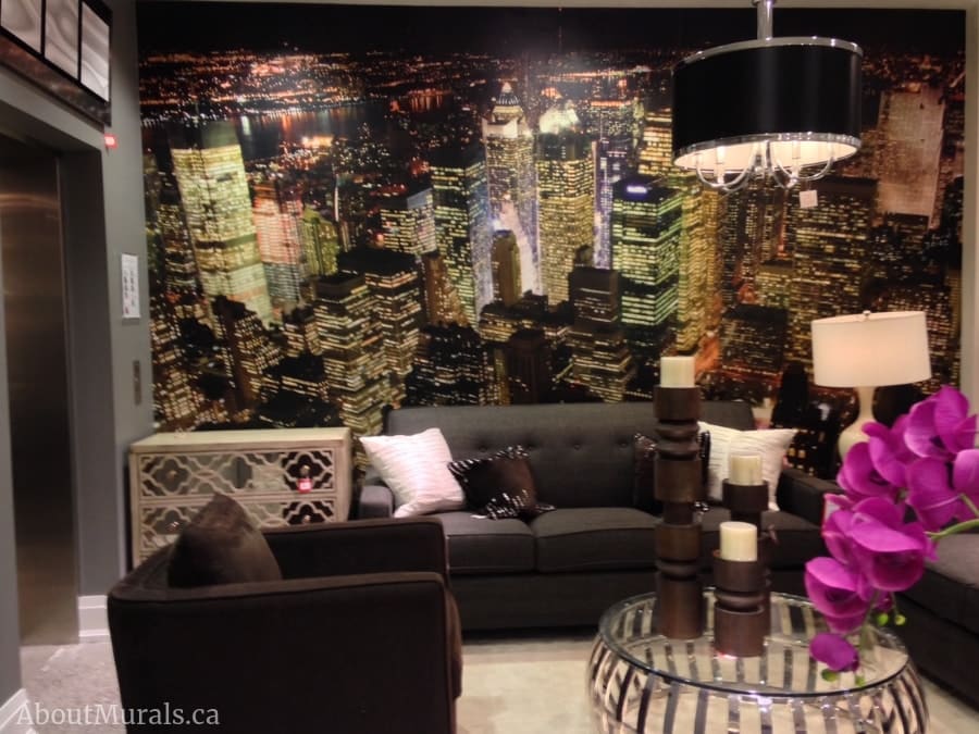 Manhattan at Night Wallpaper, as seen in this living room, features high rise buildings in NYC at night. Cityscape wallpaper sold by About Murals.