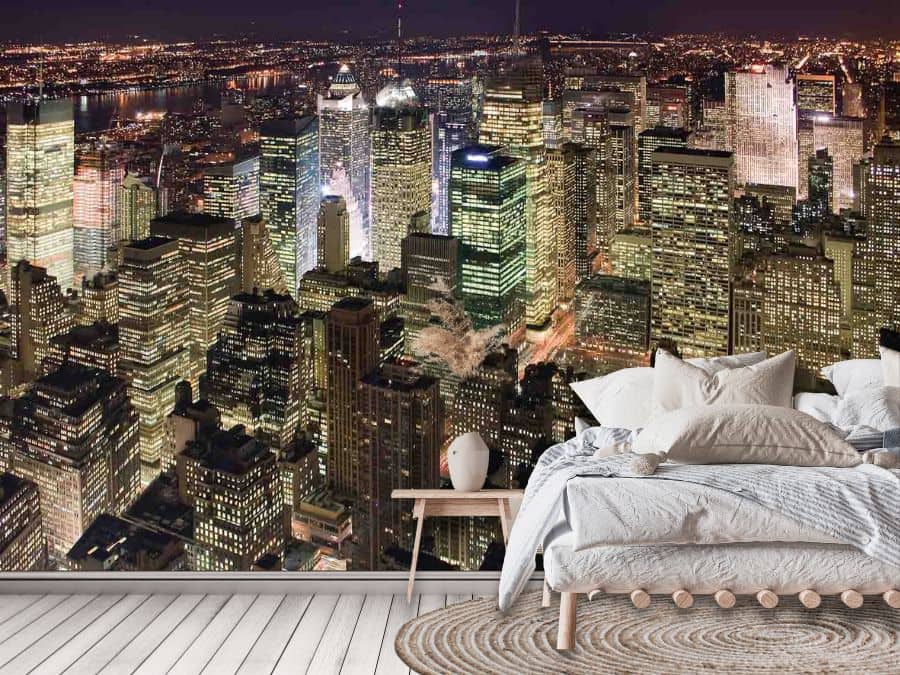 Manhattan at Night Wallpaper, as seen on the wall of this beige bedroom, is a photo wall mural of buildings in an NYC cityscape at night from above from About Murals.