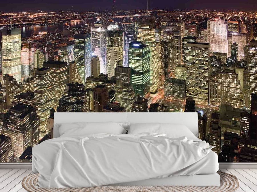 Manhattan at Night Wallpaper, as seen on the wall of this white bedroom, is a photo wall mural of a New York City skyline at night from About Murals.