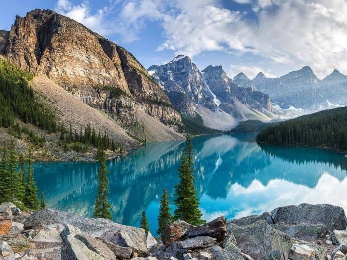 Moraine Lake Wallpaper creates tranquil walls with Alberta mountains towering over an aqua blue lake from About Murals.
