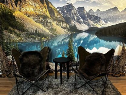 Moraine Lake Wallpaper, as seen on the wall of this cozy cottage, is a mountain wall mural with a beautiful Canadian lake from About Murals.