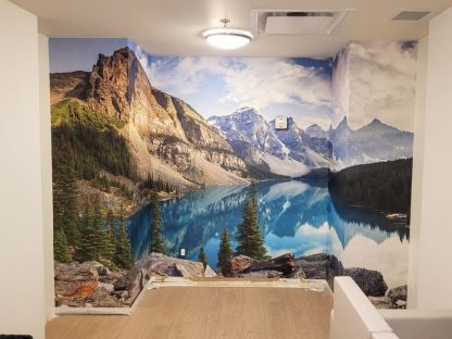 Moraine Lake Wallpaper, as seen on the wall of this hallway, is a photo mural of an Alberta skyline in Banff National Park from About Murals.
