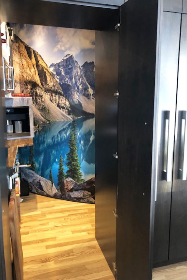 Moraine Lake Wallpaper, as seen on the wall of this modern kitchen, is a photo mural of a beautiful skyline against towering mountains in Banff National Park, Alberta, Canada from About Murals.
