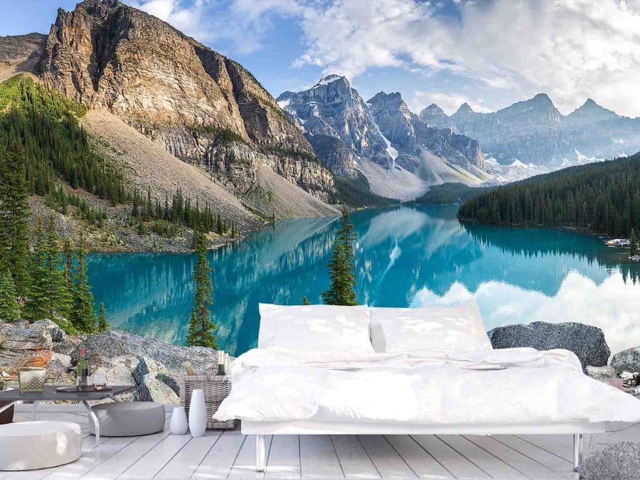 Moraine Lake Wallpaper, as seen on the wall of this white bedroom, is a high resolution photo mural of mountains towering over a blue lake in Banff National Park, Alberta, Canada from About Murals.