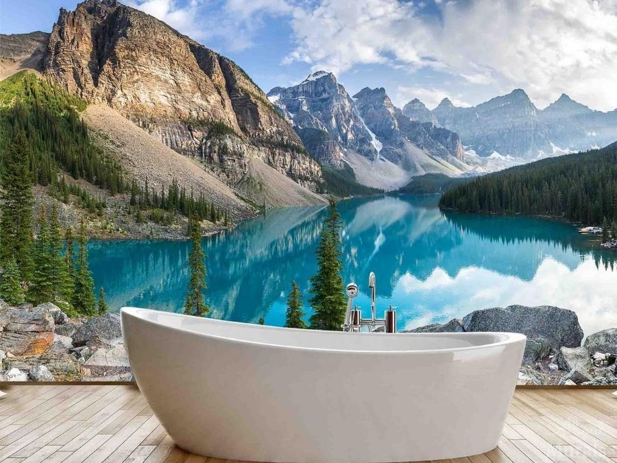 Moraine Lake Wallpaper, as seen on the wall of this bathroom, features towering mountains over a turquoise lake and pine trees. Landscape wallpaper from AboutMurals.ca.