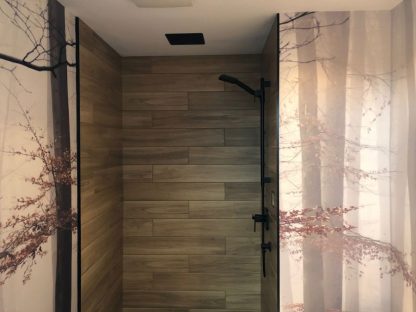 Morning Fog Wallpaper, as seen on the wall of this bathroom, is a luxury wallpaper mural of a realistic forest in grey tones from About Murals.