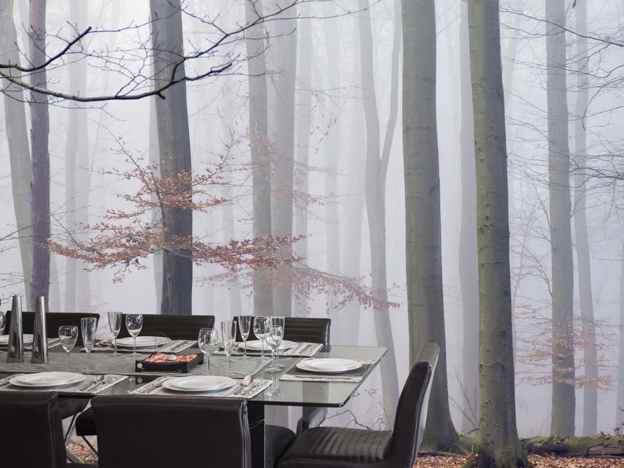 Morning Fog Wallpaper, as seen on the wall of this dining room, is a washable wall mural of peaceful trees in a gray forest from About Murals.