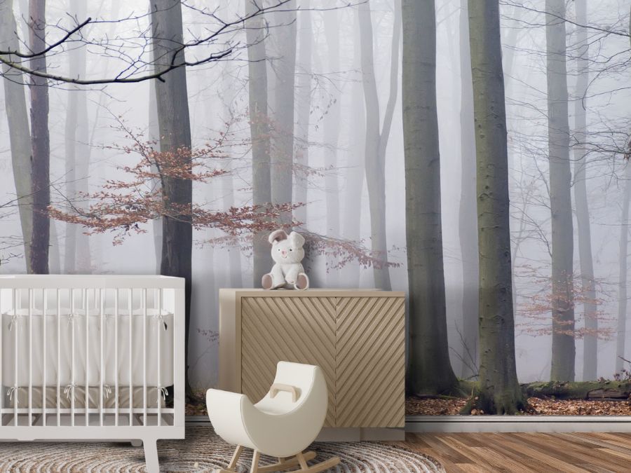 Morning Fog Wallpaper, as seen on the wall of this nursery, is a non-toxic wallpaper mural with a peaceful forest scene of mossy trees and orange leaves from About Murals.