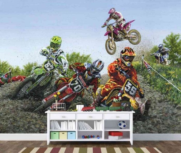 Motocross Wallpaper, as seen on the wall of this kids room, features five dirt bikes racing on a muddy track from About Murals.