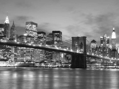 NYC Bridge Wallpaper is a city wall mural created from a photo of city lights in New York behind the Brooklyn Bridge under a black night sky from About Murals.