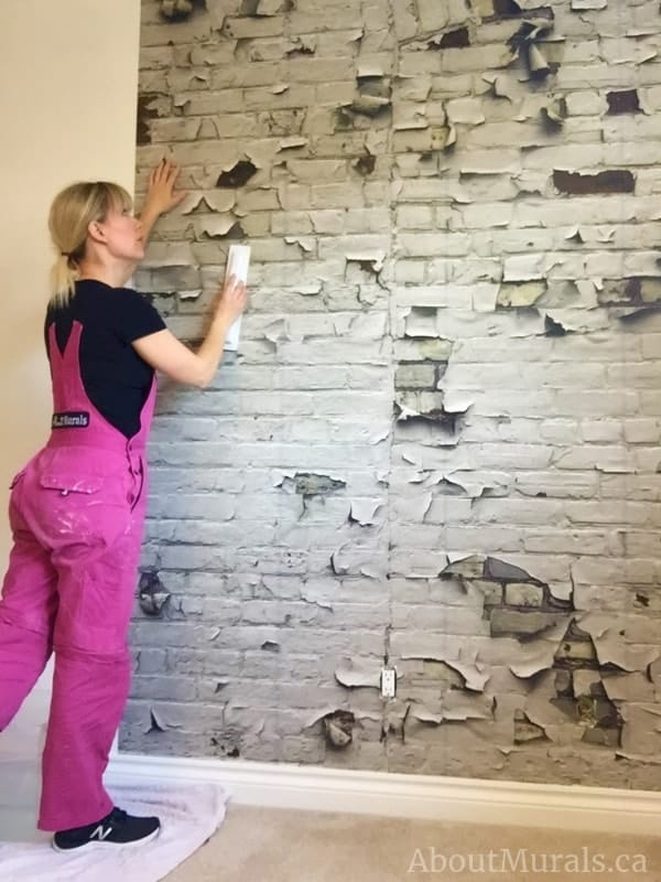 Peeling Paint Brick Wallpaper is a distressed, textured design that's easy to hang. White brick wallpaper sold by AboutMurals.ca.