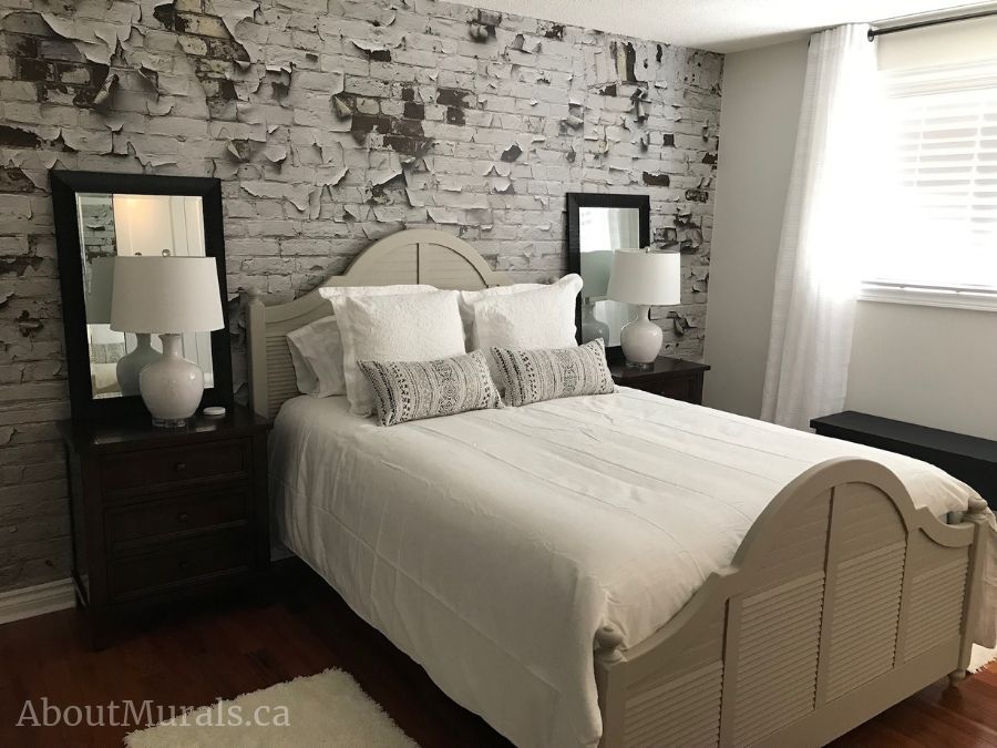 Peeling Paint Brick Wallpaper, as seen on the wall of this light bedroom, creates a distressed, textured look. White brick wallpaper sold by AboutMurals.ca.