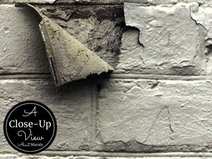 A close-up view of Peeling Paint Brick Wallpaper, which is a white distressed brick wallpaper design from About Murals