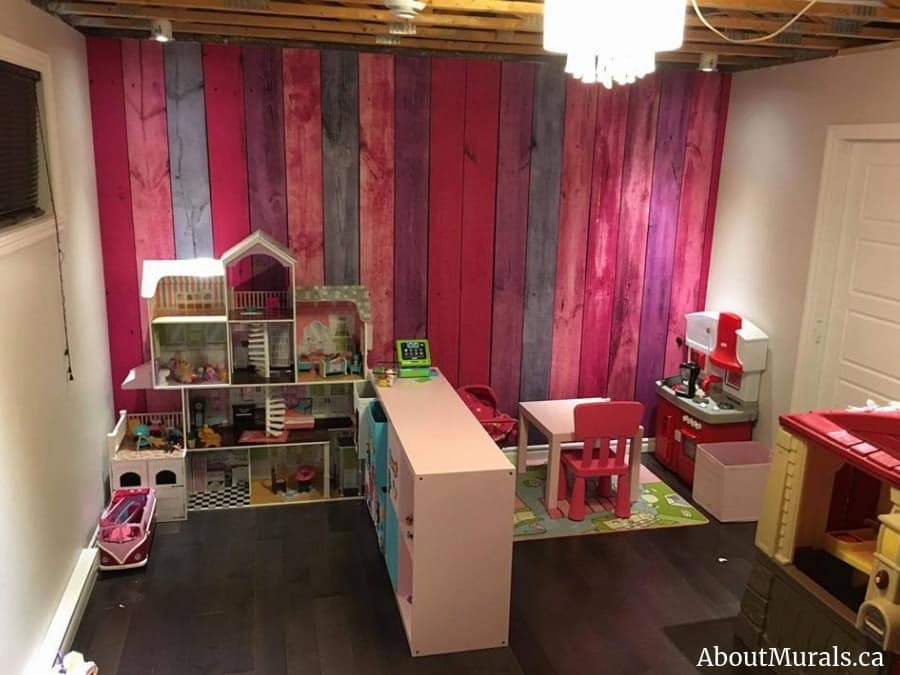 Pink Wood Wallpaper, as seen in a playroom, creates a beautiful textured wall with its reclaimed wooden planks. Kids wallpaper sold by AboutMurals.ca.