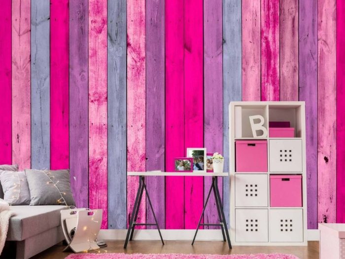 Pink Wood Wallpaper, as seen on the wall of this kids room, features hot pink and muted purple wooden planks from About Murals.