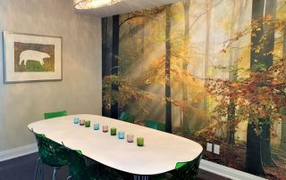 Sinfonia Della Foresta Wall Mural, as seen in this dining room, is an autumn forest wallpaper with sun shining through yellow trees from About Murals.