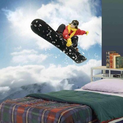 Snowboard Wallpaper, as seen on the wall of this bedroom, features a girl making a sick jump over snow-capped mountains from About Murals.