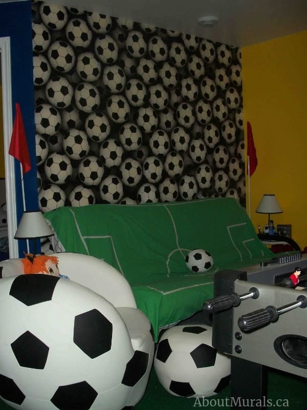 Soccer Balls Wallpaper, as seen on the wall of this sports room, features black and white 3D balls. Soccer wallpaper sold by AboutMurals.ca.