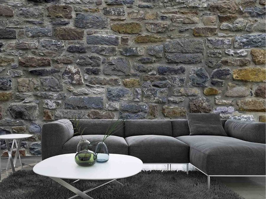 Stone Wall Mural, as seen in this grey living room, is a stone wallpaper created from a high resolution photo offering a textured look from About Murals.