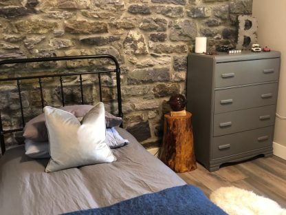 Stone Wall Mural, as seen in this kid's room, is a high res photo mural of realistic grey, blue and green stones full of texture from About Murals.