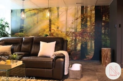 Sunny Autumn Wallpaper, as seen in this dark living room, is a photo wall mural of sunrays shining through yellow trees in a fall forest from About Murals.