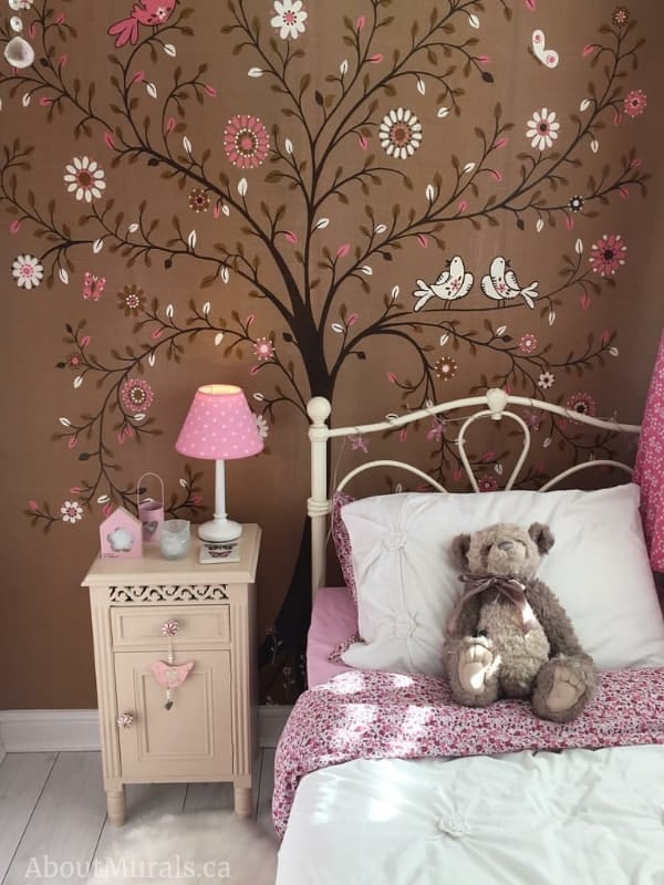 Tree of Life Brown Wall Mural, seen in this girls bedroom, features a whimsical tree full of flowers, butterflies and birds on a brown background. Kids wallpaper sold by AboutMurals.ca.