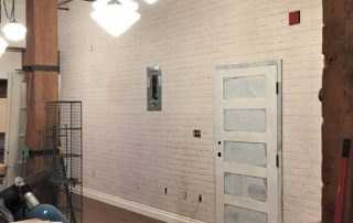 White Brick Wall Mural, as seen in this loft, adds a ton of texture to walls with its white painted brick. Brick wallpaper sold by AboutMurals.ca.