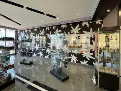 Custom wallpaper for retail, like this black and white cannabis design, from About Murals.
