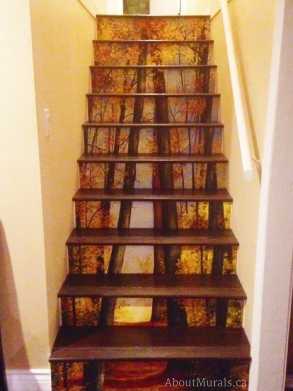 A stair riser wallpaper in a forest theme with dark stair treads, sold by AboutMurals.ca