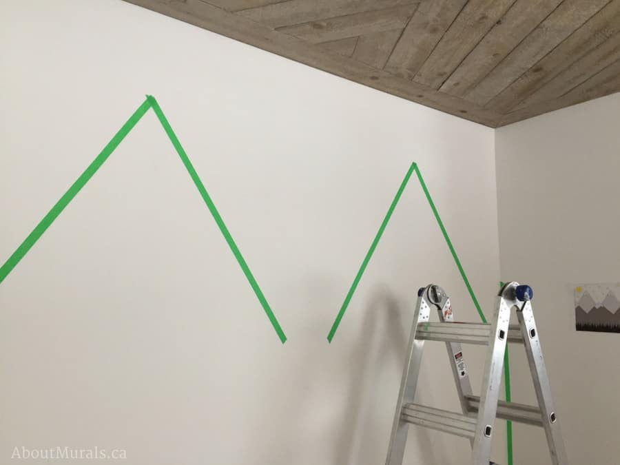 DIY Mountain Mural by taping off the upper mountains on the wall like Adrienne of AboutMurals.ca