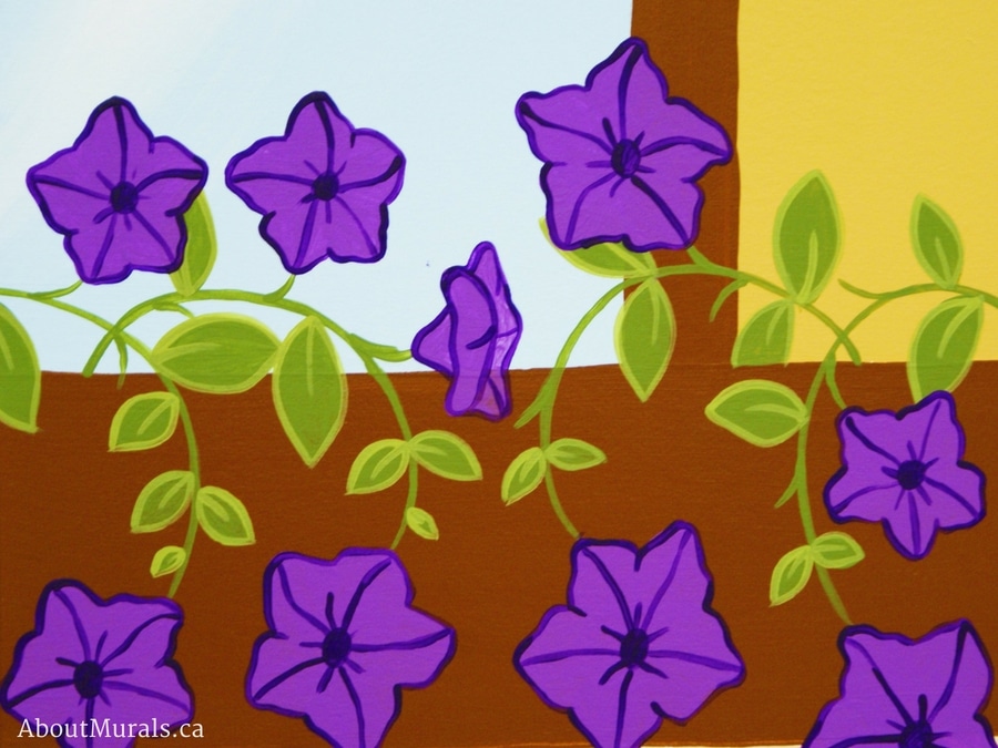Adrienne of AboutMurals.ca painted purple petunia flowers in a kids mural
