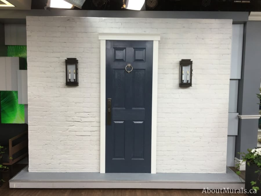 White Brickwork Wallpaper that shows the bricks to scale against a door and lights on set at Cityline - About Murals